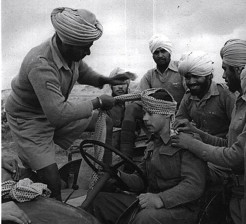 Sikh tying turban to a British soldier in World war 1