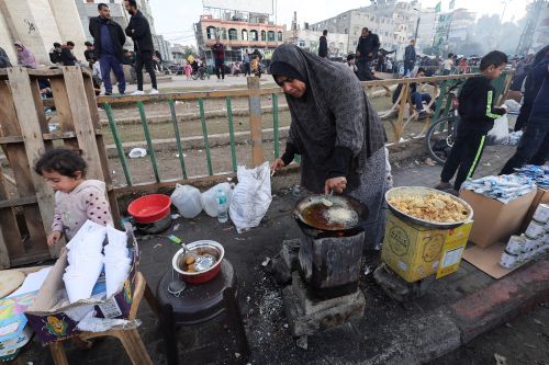 A Palestinian woman cooks at a market. Reuters/Ibraheem Abu Mustafa